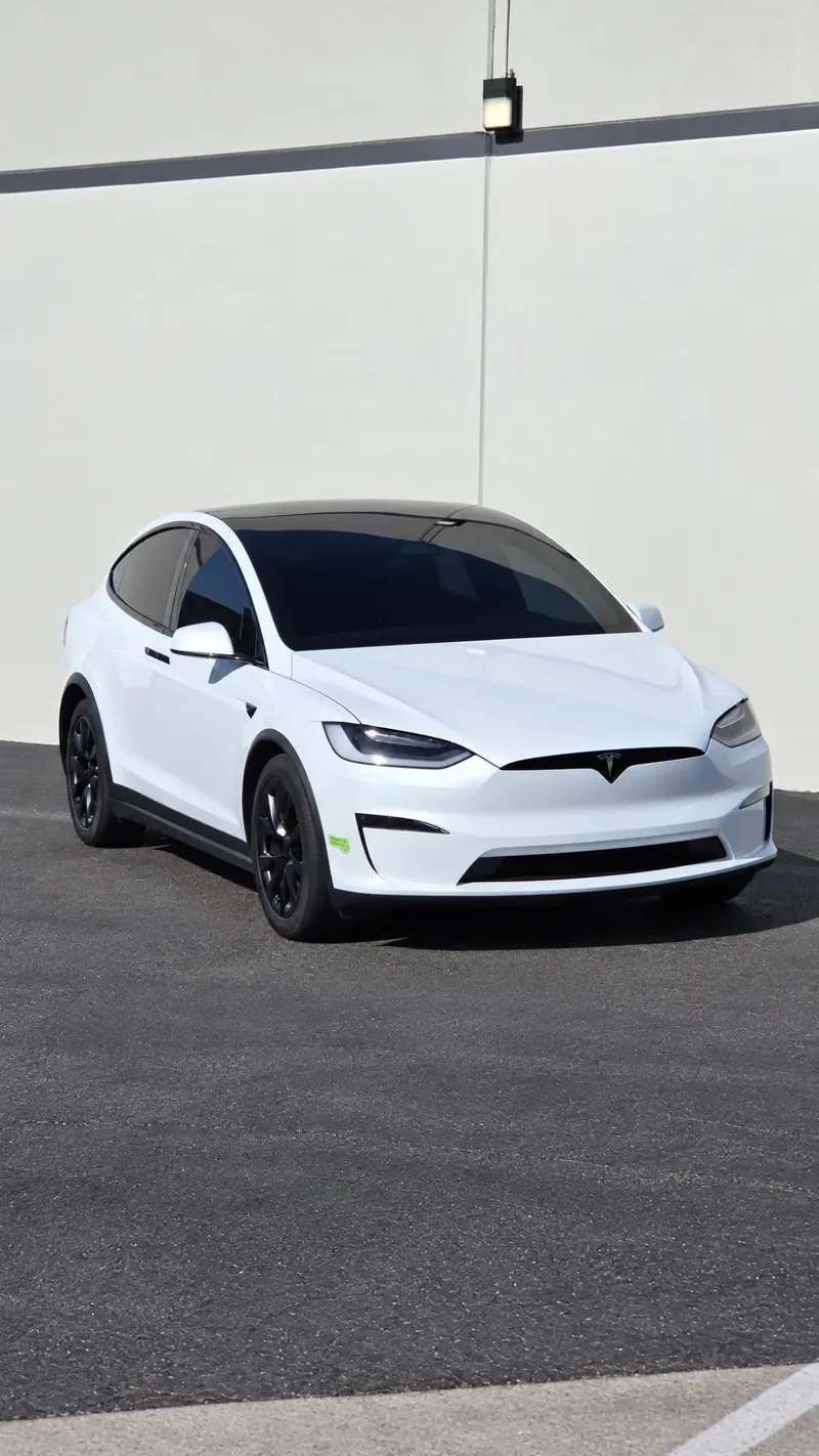 White Tesla Model X with tinted windows outside the Avanti Window Tint shop in San Diego
